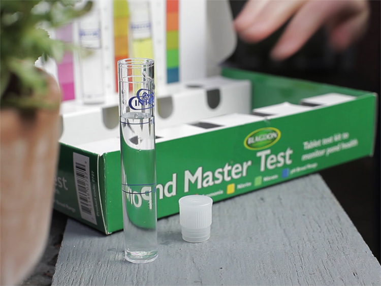 Green box with colour charts and plastic vials